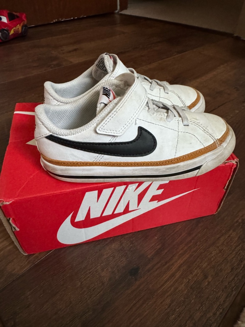 Nike Kids White Sneakers with Black Swoosh and Tan Trim